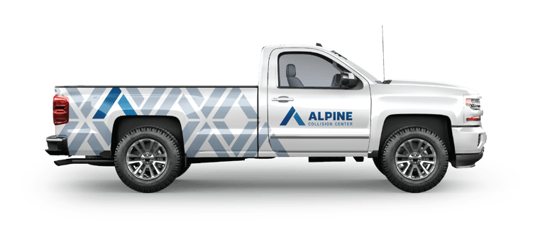 Pickup truck with alpine collision center decals