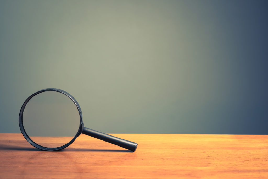 Magnifying glass on wood table