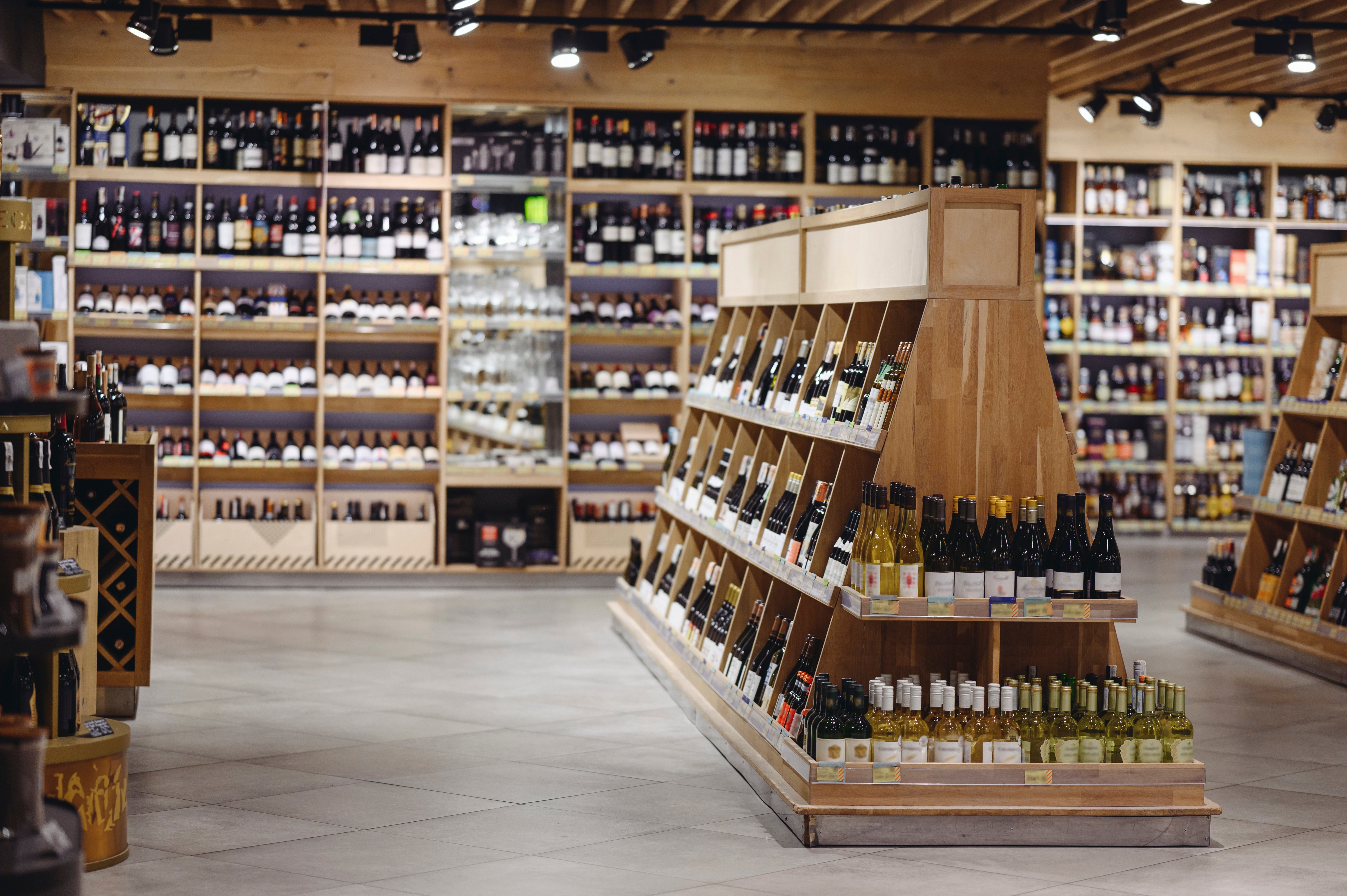Wine shop shelves stocked with hundreds of bottles, representing overwhelming consumer choice.